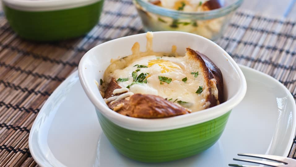 baked eggs in a basket with asiago