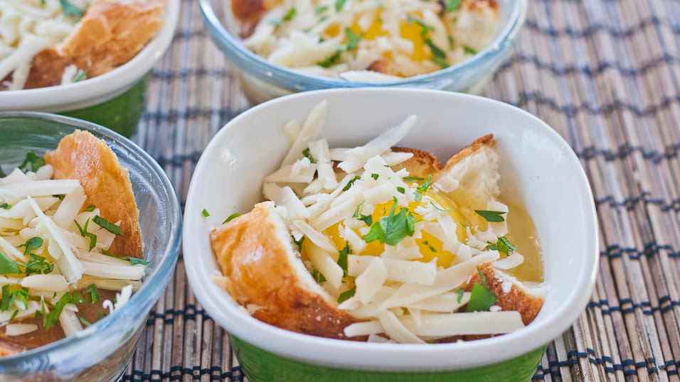 baked eggs in a basket with asiago