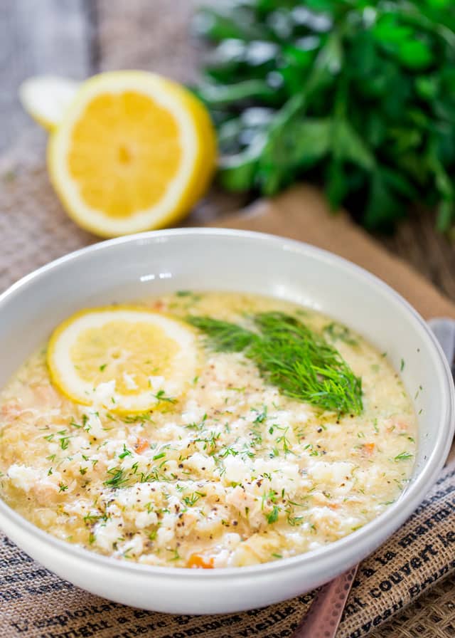 Avgolemono Soup in a bowl with a slice of lemon and fresh dill