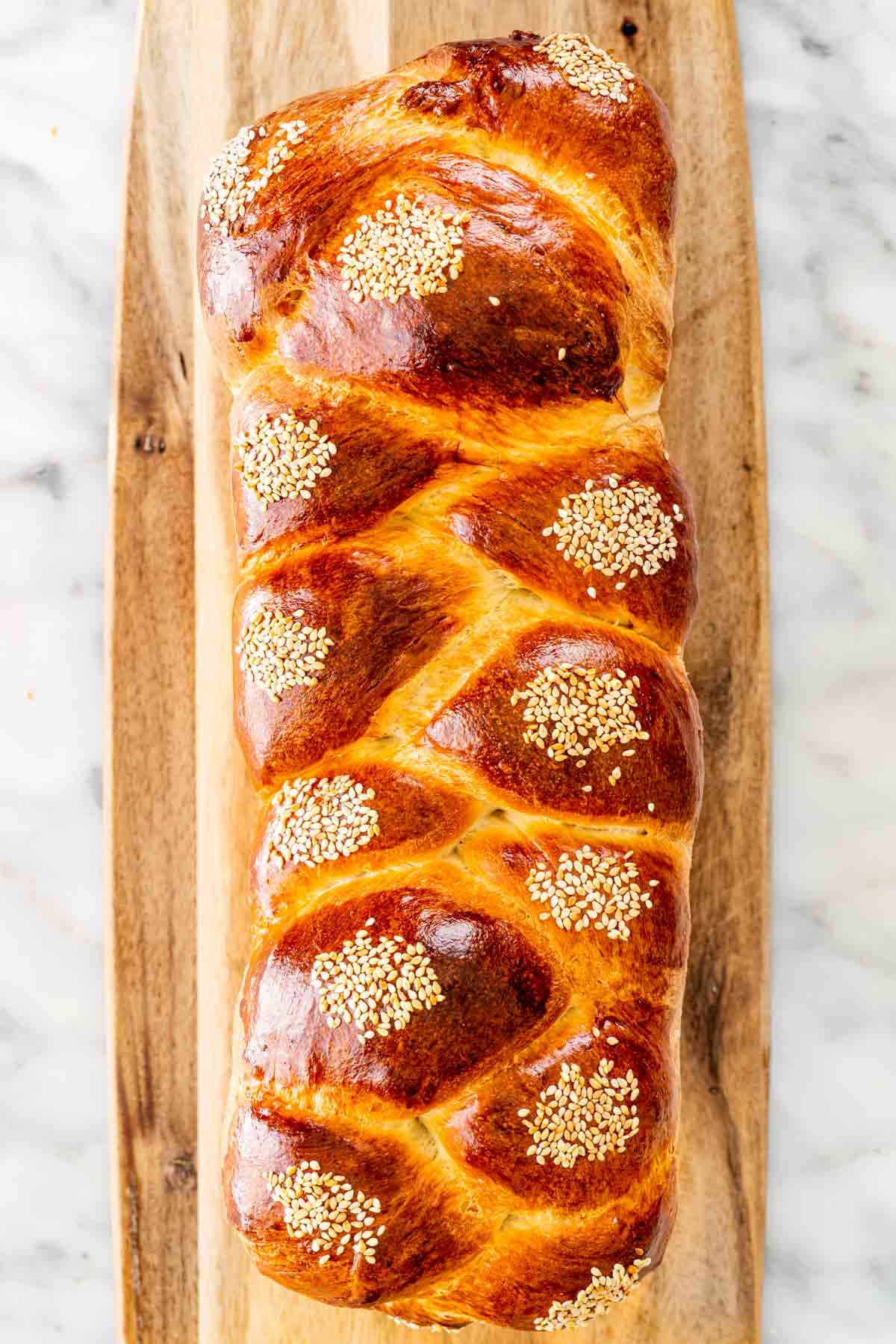 a braided easter bread on a cutting board