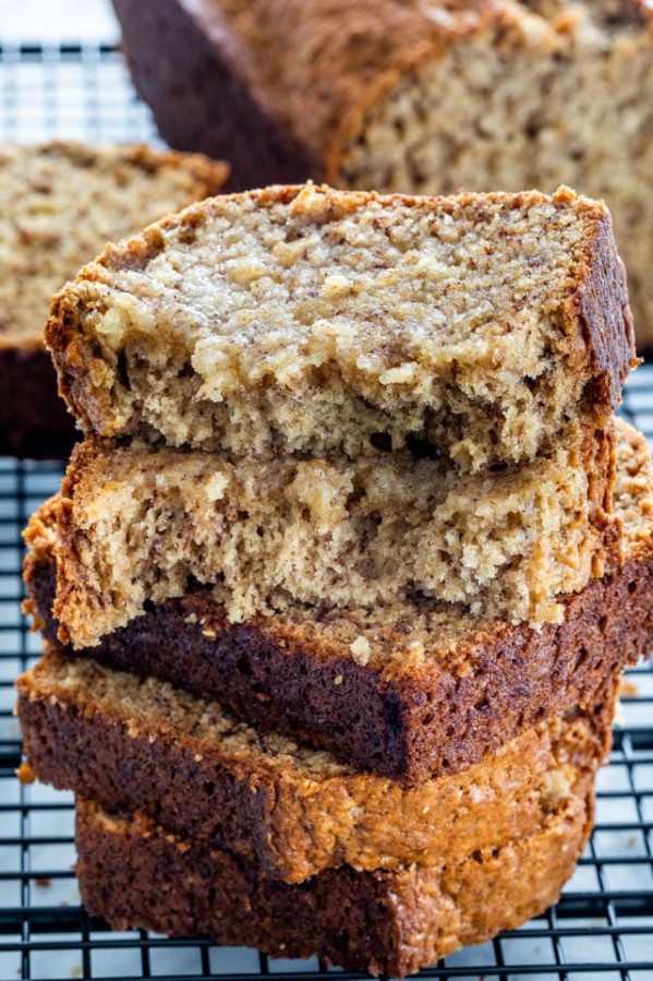 slices of banana bread stacked on a cooling rack