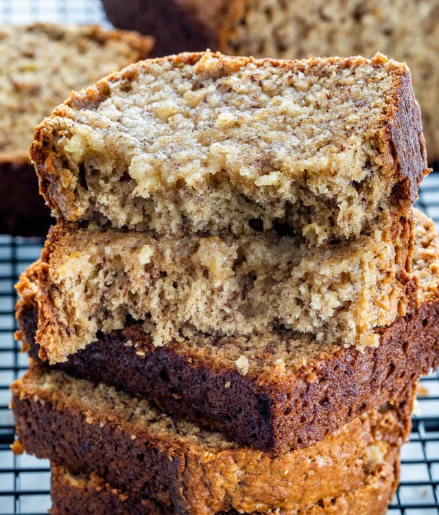 slices of banana bread stacked on a cooling rack