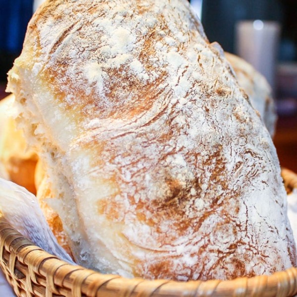 a loaf of ciabatta bread in a wicker basket