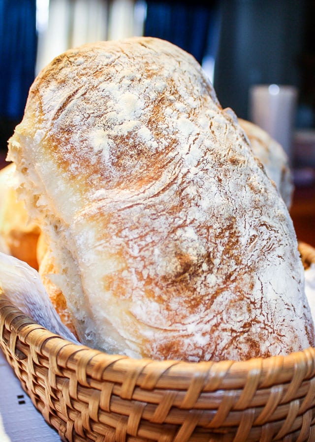 A delicious looking, homemade ciabatta bread in a basket. 