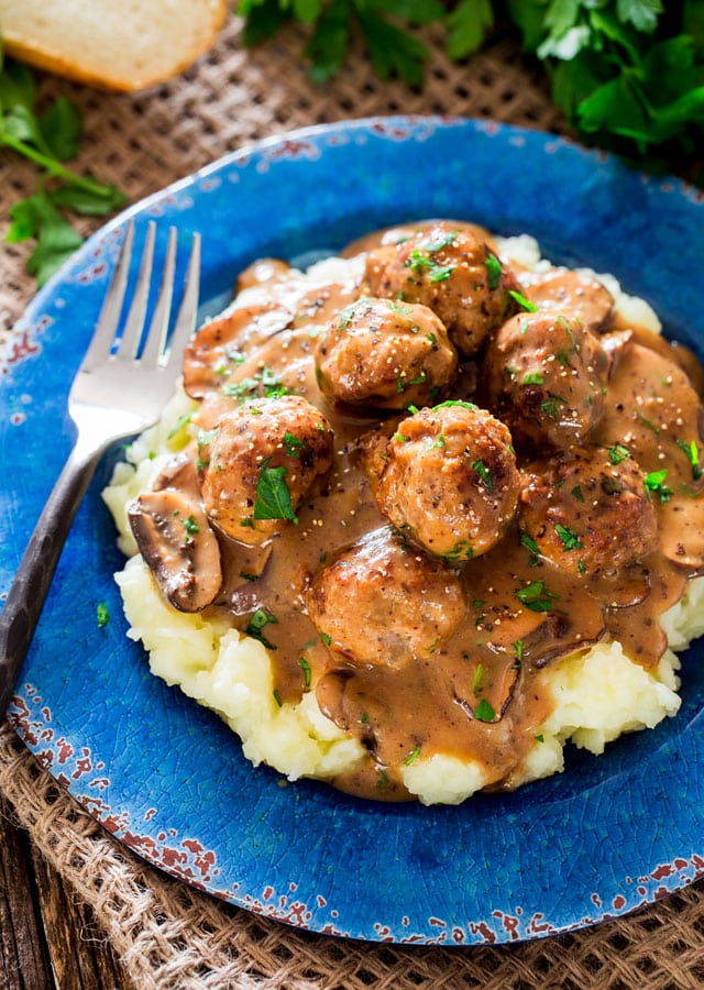 Meatballs with Mushroom Sauce over a bed of mashed potatoes in a blue plate