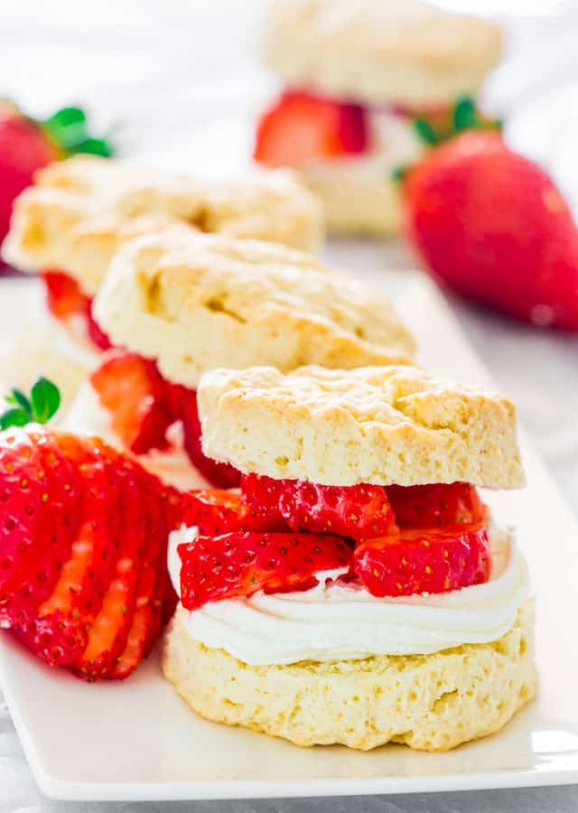 Strawberry Shortcakes on a plate garnished with sliced whole strawberries