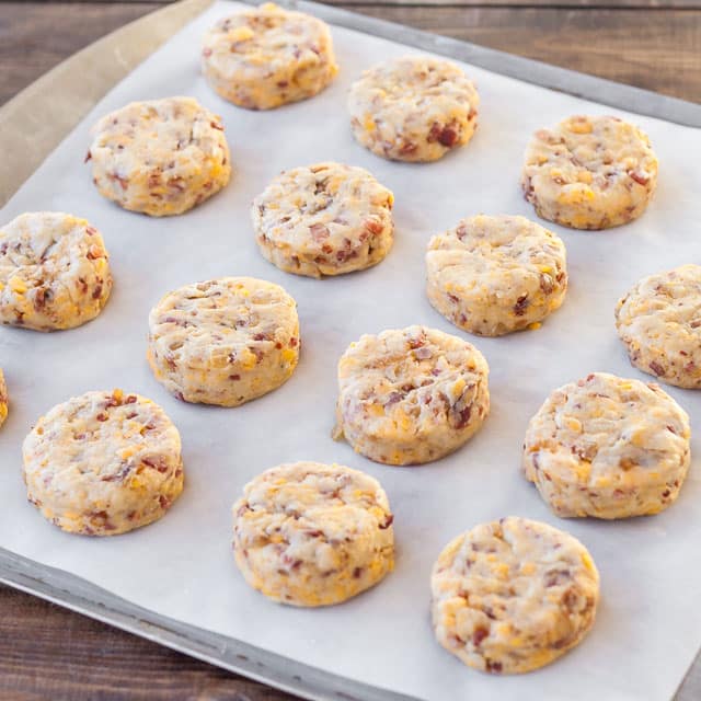 Bacon Cheddar Biscuits lined up on a tray.