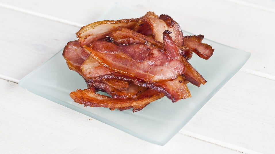 A pile of cooked bacon strips