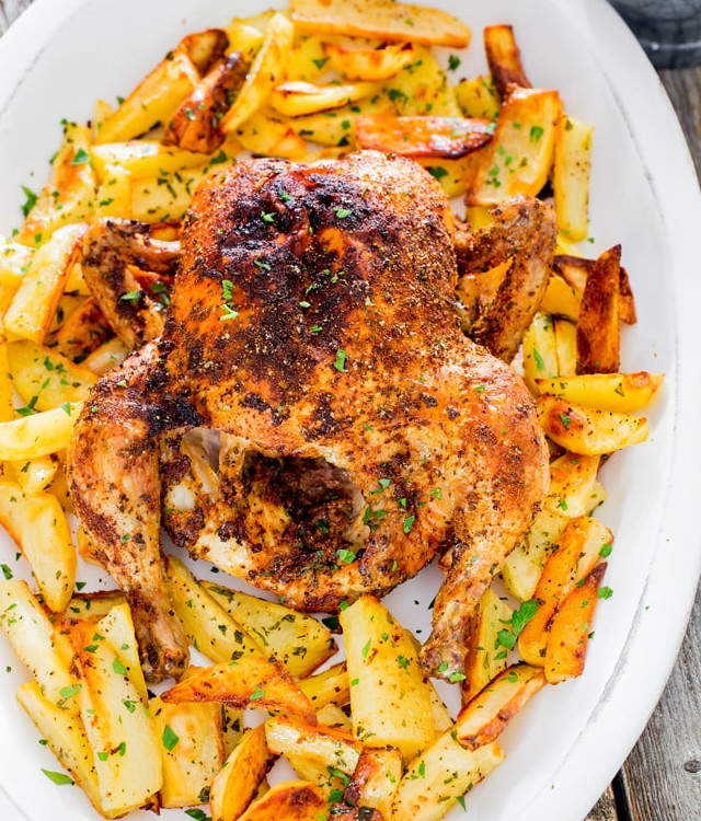 roast chicken with roasted potatoes on a plate