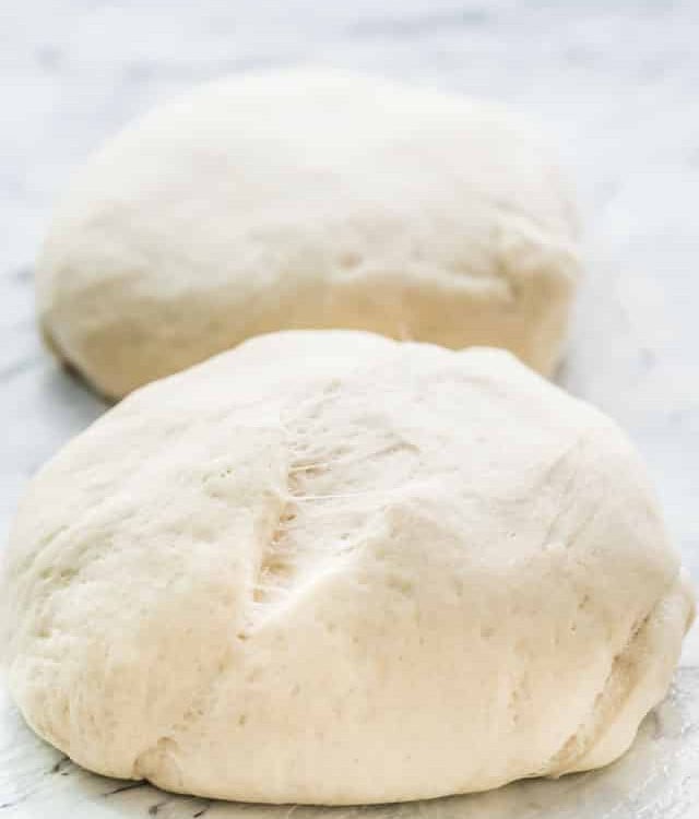 side view shot of two balls of pizza dough