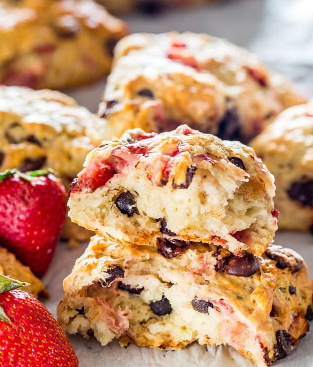 side view shot of a strawberry chocolate chip scone broken in half exposing the center