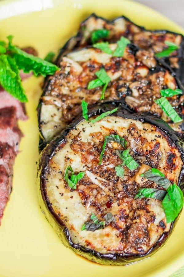 grilled eggplant slices with garlic sauce and mint