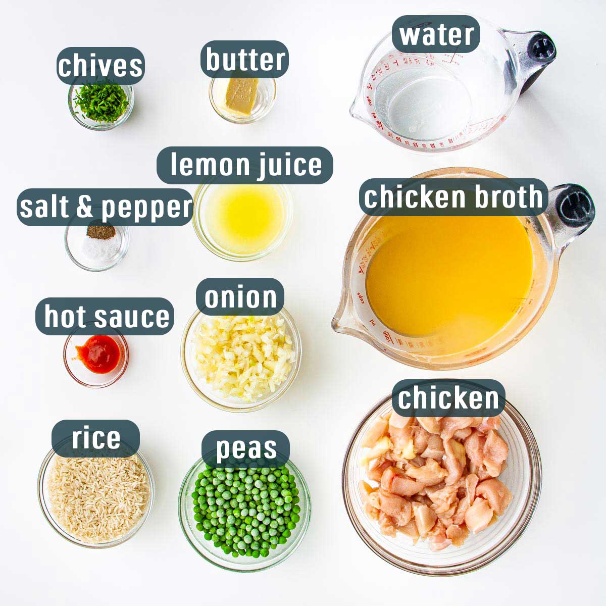 overhead shot of all the ingredients needed to make lemon chicken soup with rice and peas.