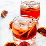 two americano cocktails in short classes, garnished with blood oranges