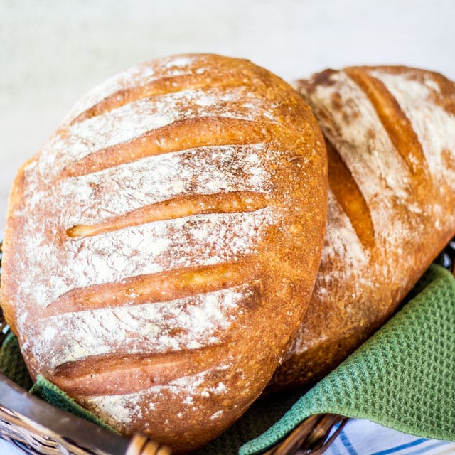 2 loaves of artisan bread in a bread basket