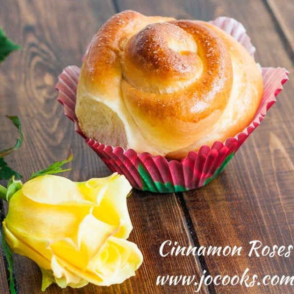 a freshly baked cinnamon rose with a fresh yellow rose resting in front