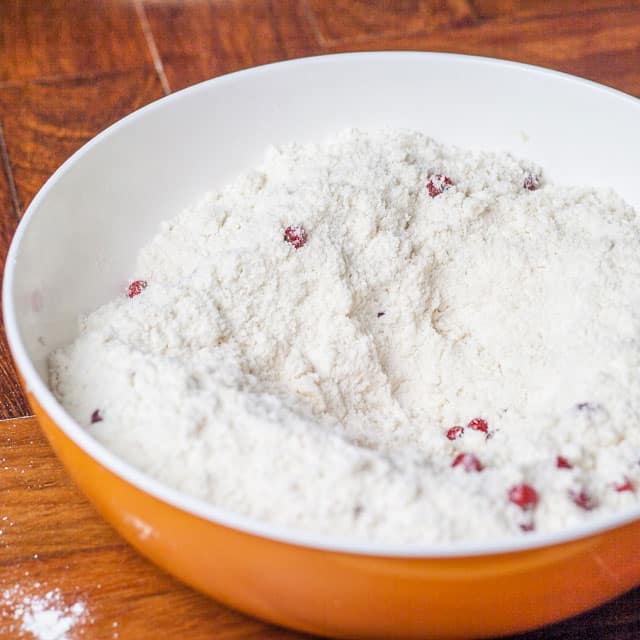 flour, sugar, baking powder, baking soda, currants and salt in a bowl