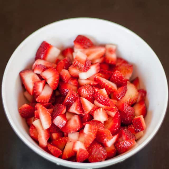 Overhead shot of chopped strawberries in a bowl