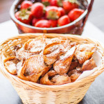 a basket full of nutella and strawberry wontons dusted with powdered sugar