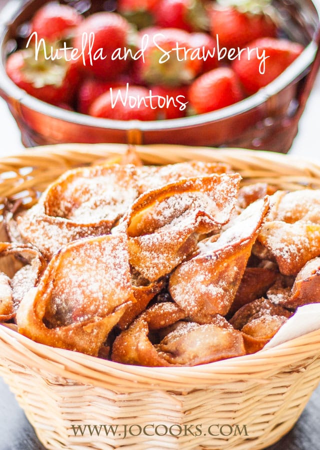 a basket of nutella and strawberry wontons dusted with powdered sugar