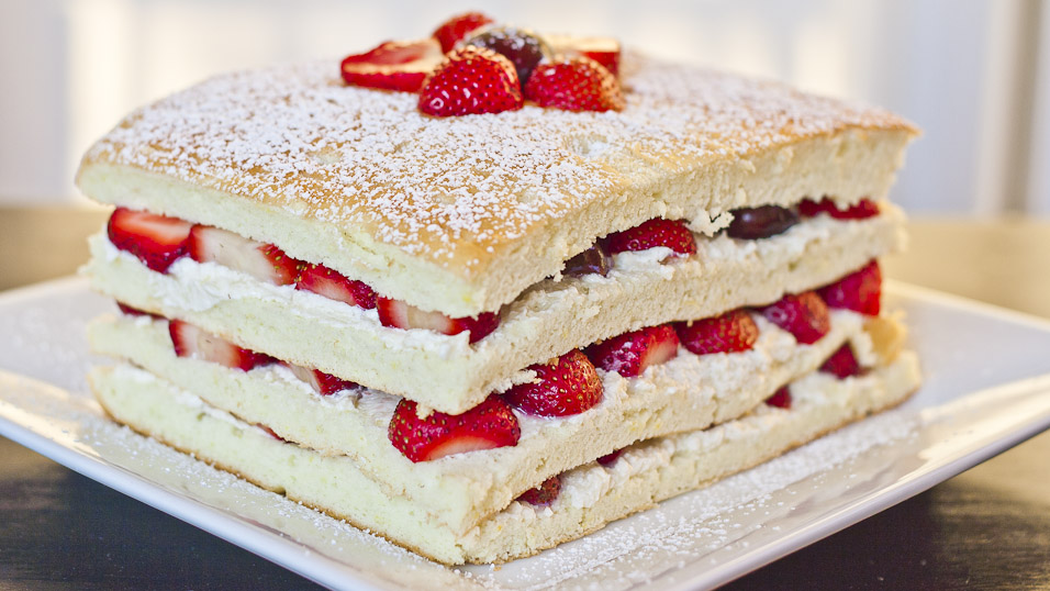 Summer Cake with Strawberries and Cherries dusted with powdered sugar