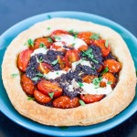 a tomato and tapenade tart with mascarpone cheese on a plate
