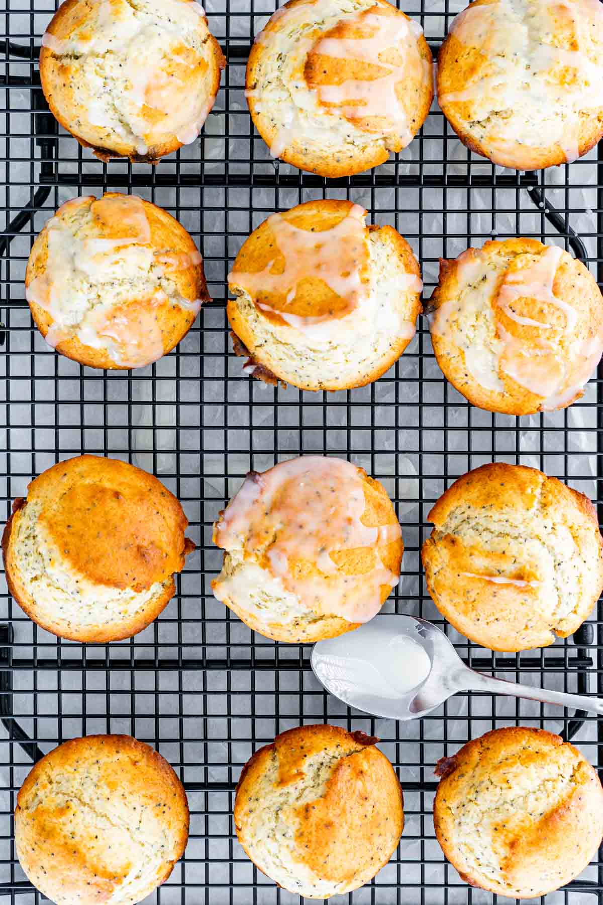 overhead shot of lemon poppy seed muffins drizzled with lemon glaze on a cooling rack