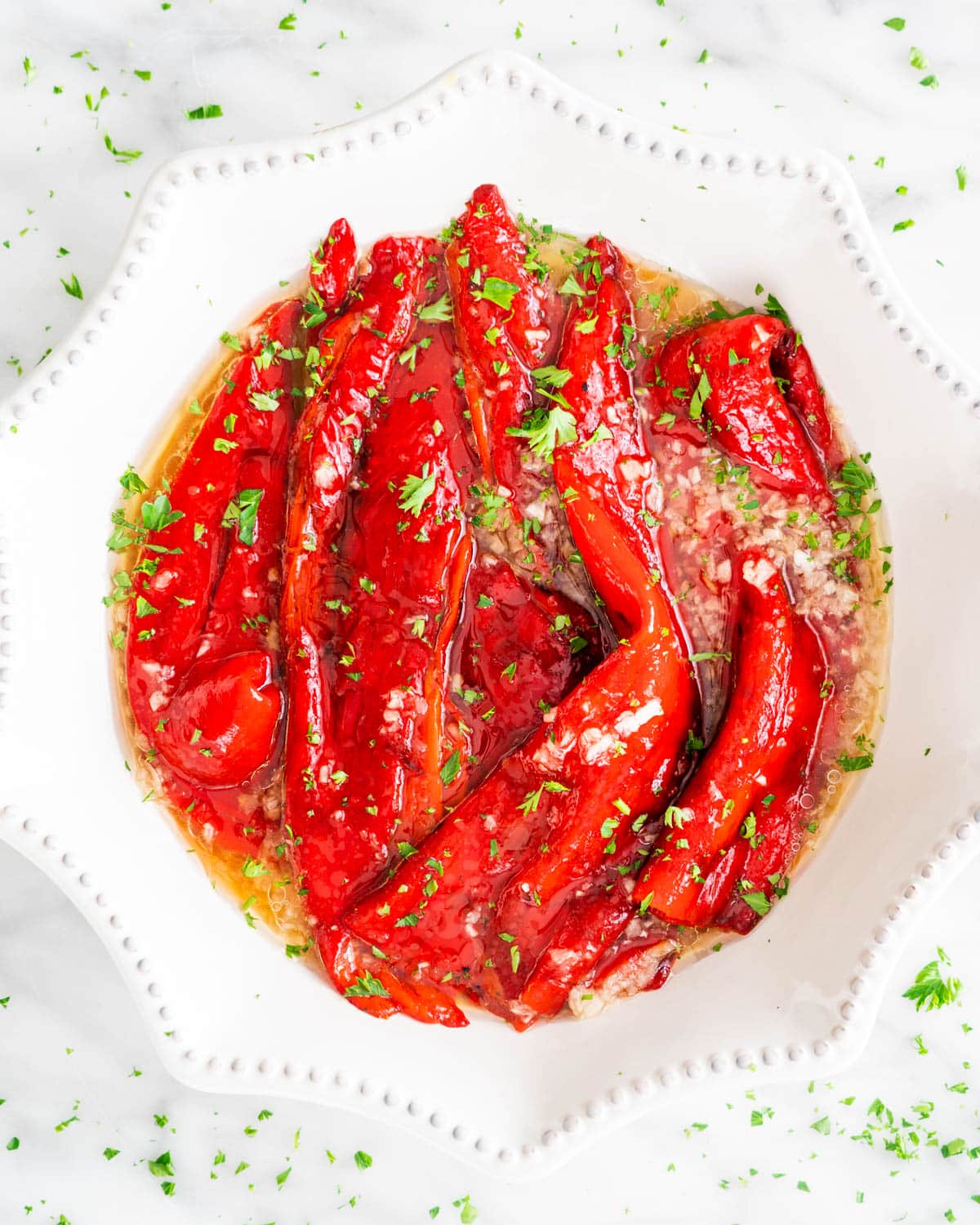 Roasted Red Peppers in a white bowl in a garlic sauce