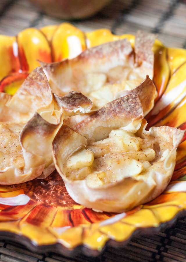 3 mini apple pies in wonton wrappers on a plate