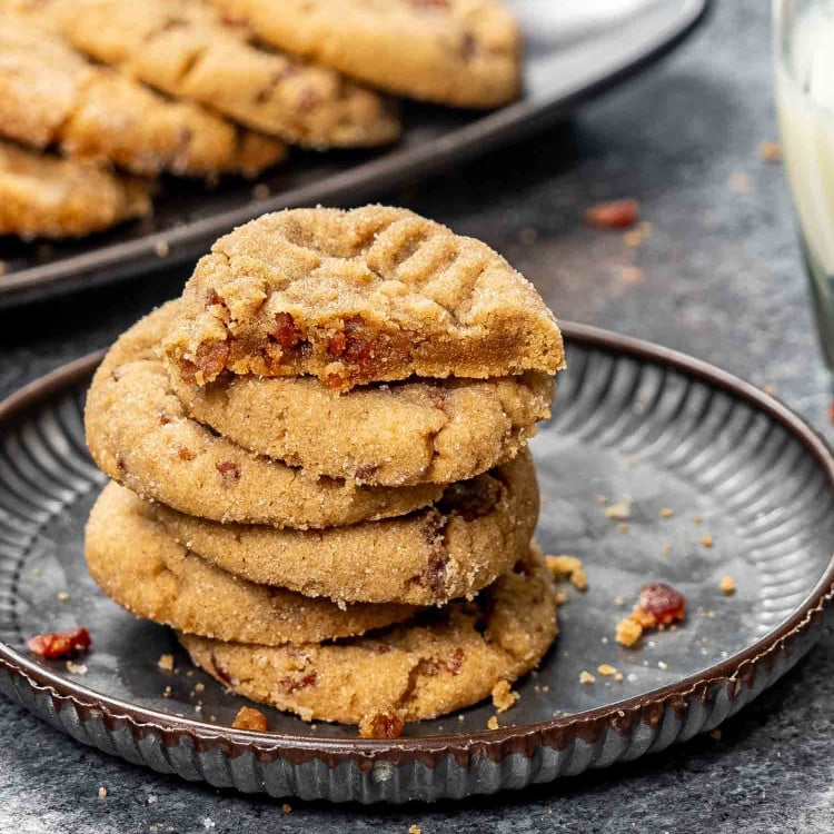 a stack of peanut butter bacon cookies on a plate.