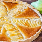a gorgeous pear and almond cream tart on a table.