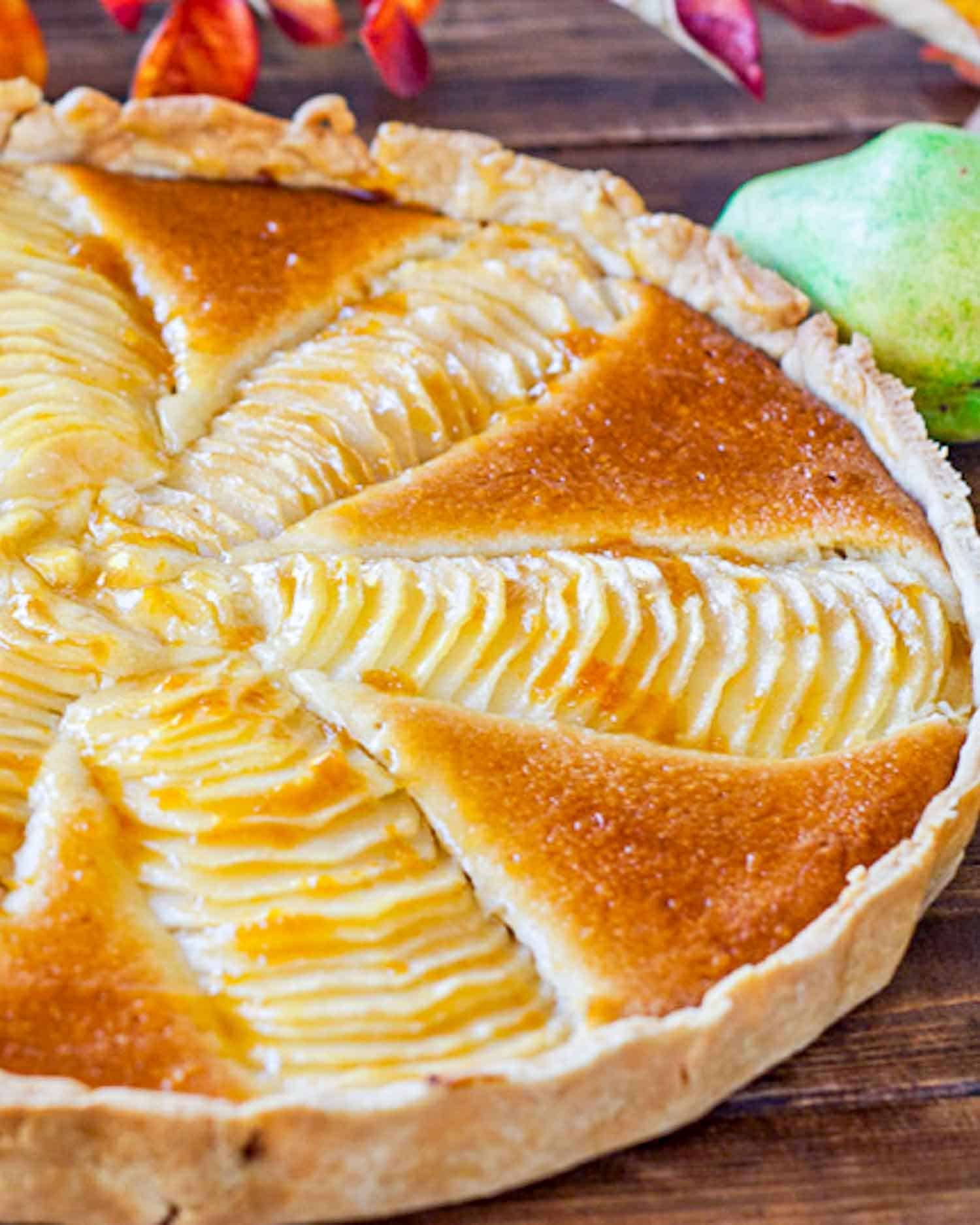 a gorgeous pear and almond cream tart on a table.