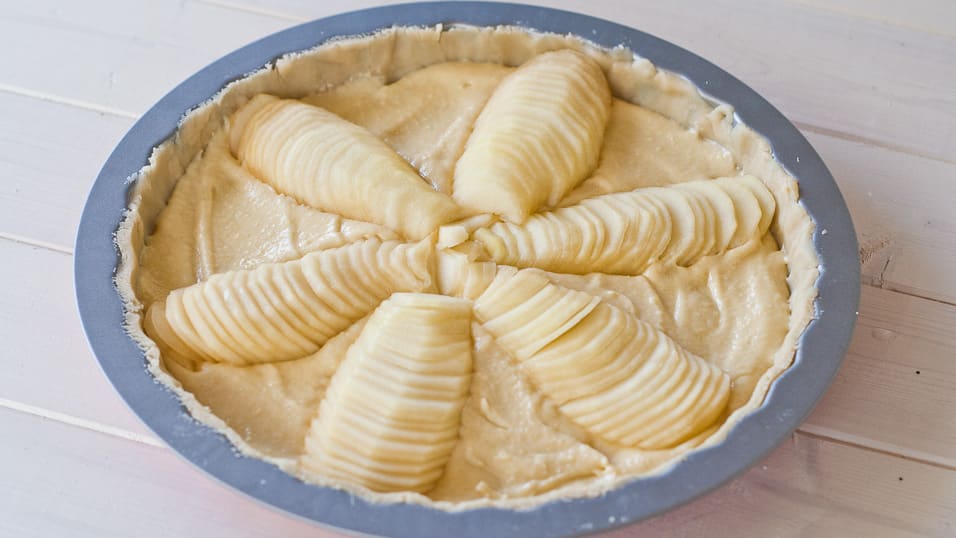 Sliced pears are added on top of the almond cream in a flower shape