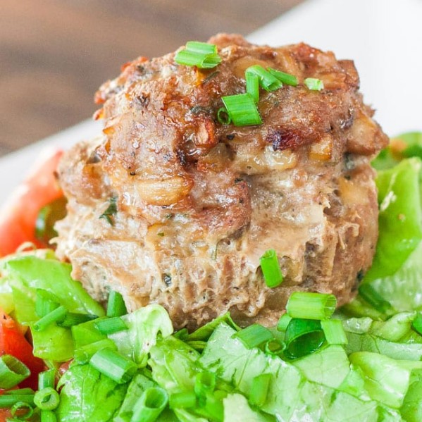 a turkey meatloaf meatball on top of a bed of greens