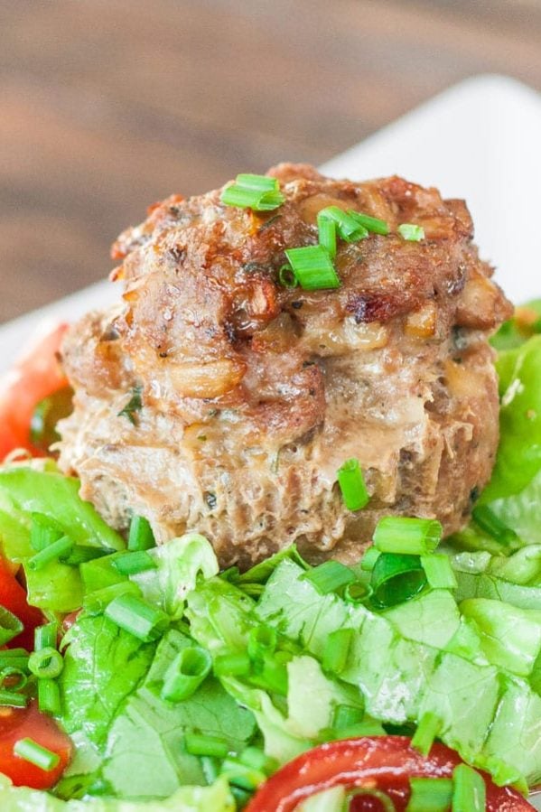 a turkey meatloaf meatball on top of a bed of greens