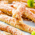 side view shot of cheese sticks scattered all around