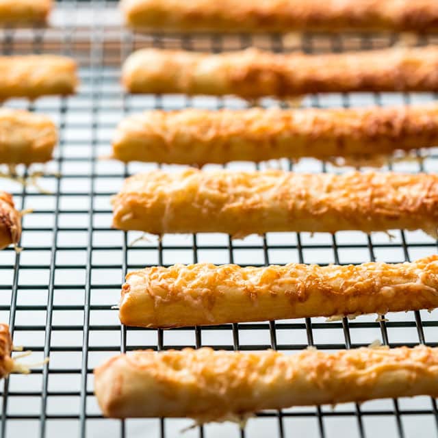 cheese sticks lines up on a cooling rack