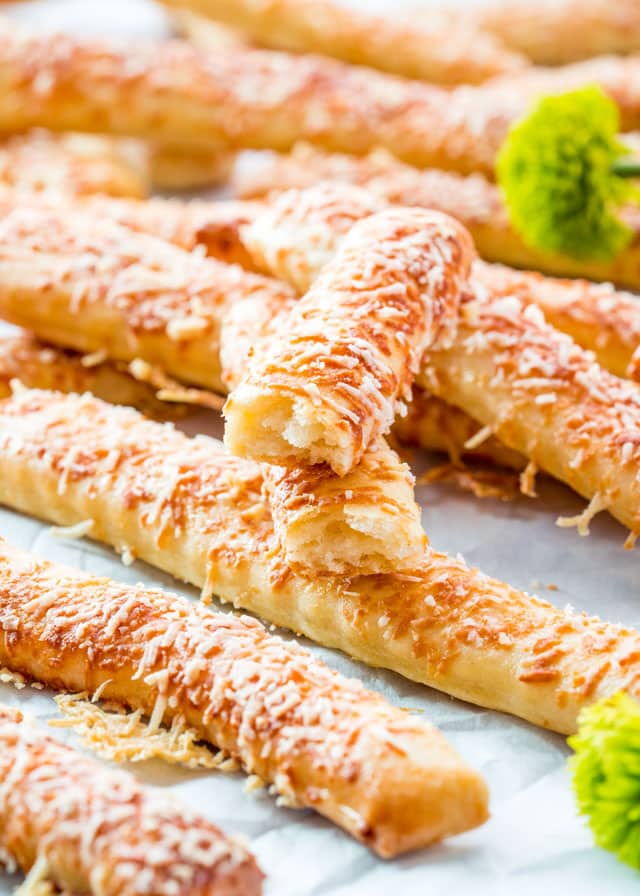 side view shot of cheese sticks scattered all around