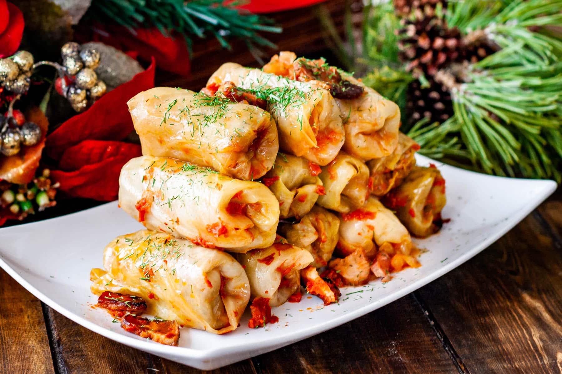 stacked romanian cabbage rolls on a white plate 