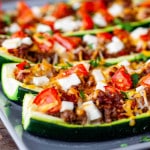 stuffed zucchini on a blue plate.