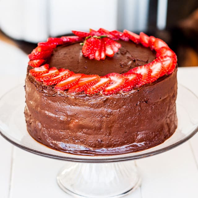 Chocolate Cake with Mixed Berry and Cream Cheese Filling decorated with strawberry slices