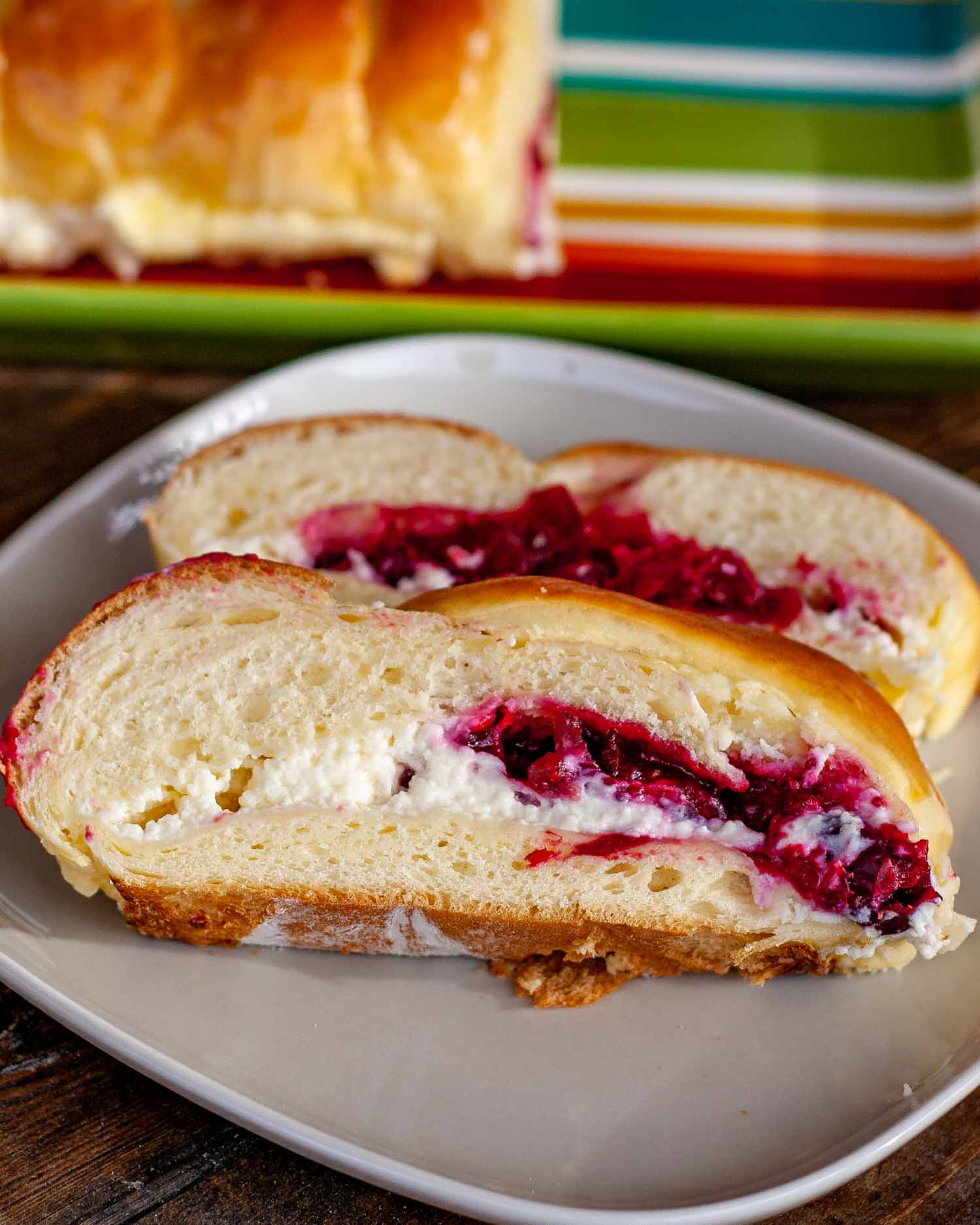 two slices of cranberry cream cheese bread on a plate.
