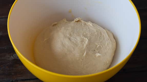 Brioche Dough in a plastic bowl