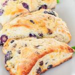 three blueberry and chocolate chip scones on a plate