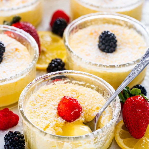 ramekins of lemon pudding cakes garnished with berries.