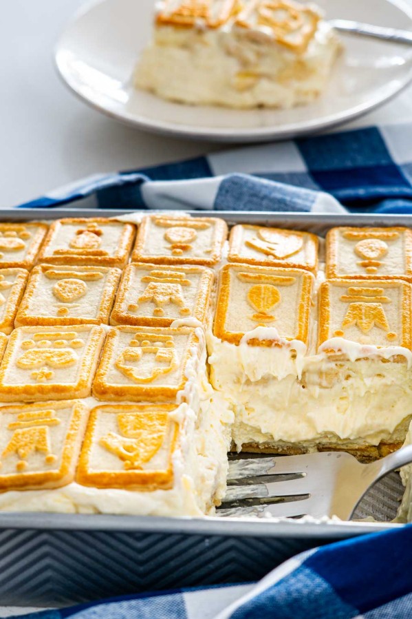 banana pudding in a pan with a portion taken out of it.