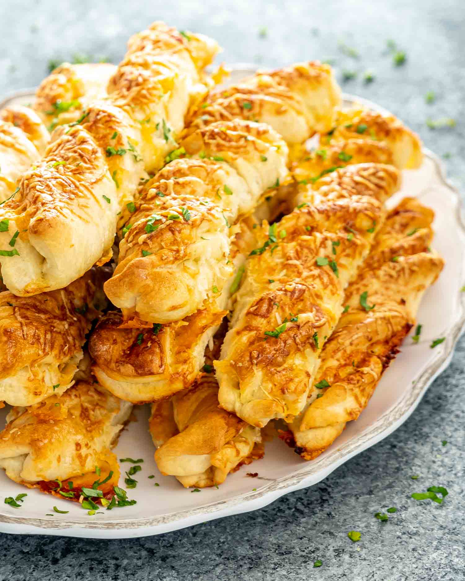 freshly baked cheesy breadsticks on a serving platter.