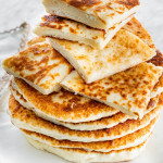 sliced feta fry bread stacked on top of whole fry bread pieces
