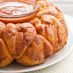 pizza monkey bread with a bowl of marinara sauce in the middle