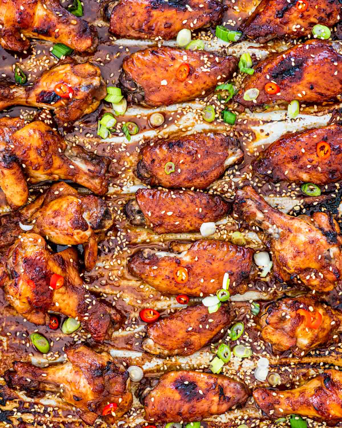 overhead shot of sticky chinese chicken wings on a baking sheet
